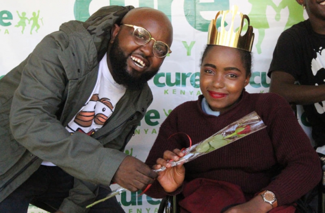  Gospel Artist Moji Short Baba gives Monicah Wanjiru, 14years, of Joy Town school, Thika, as early Valentine during the 5th edition of Night to shine at AIC-Cure International hospital 