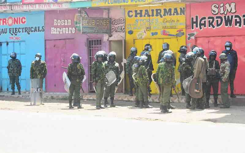 Armed officers escort protesters along the streets