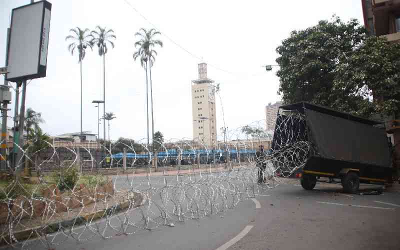 The House that fell now hides behind razor wire