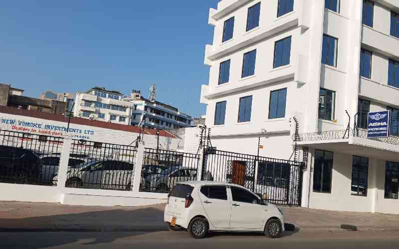 Old buildings give way to used-car showrooms