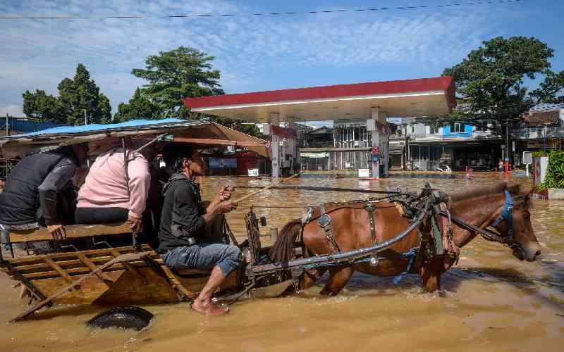 Survivors pick up pieces in flood-hit Indonesia as more rain predicted