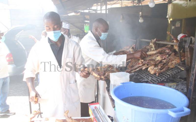 Staff roasting meat at the stall.