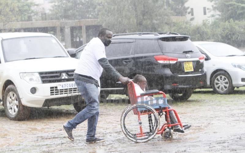 Man braves rain to register daughter.