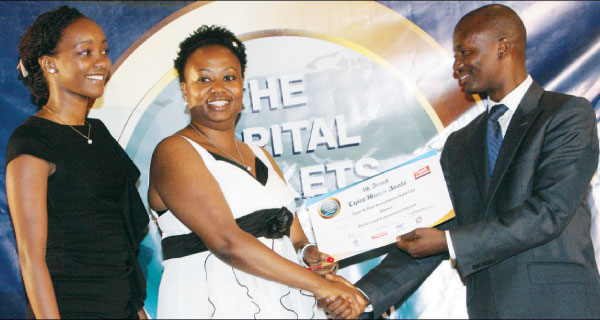 Diamond Trust Bank staff members  join their CEO Nasmin Devji (middle) in celebrating her award for CEO of the Year during the 4th Annual Capital Markets Awards organised by Think Business at Hotel Intercontinental on Wednesday. [Photo: Jonah Onyango/STANDARD]