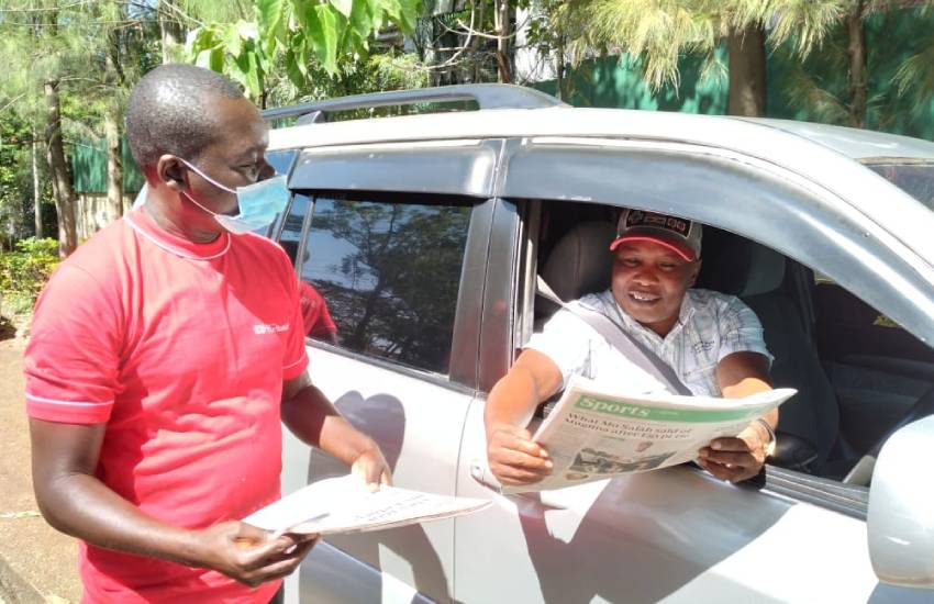 Kisumu resident receives a copy of The Standard.