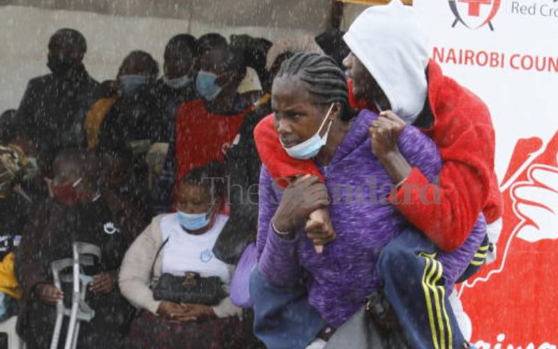 Mother braves rain with son to grace the event.
