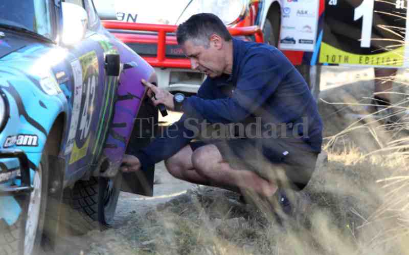 Navigator Alex checking his Porsche 911.