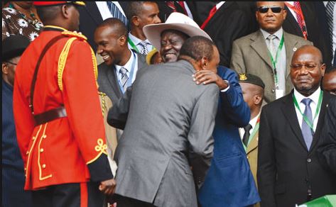 Former PM Raila Odinga hugs President Uhuru Kenyatta Thursday at the Safaricom Stadium, Kasaran