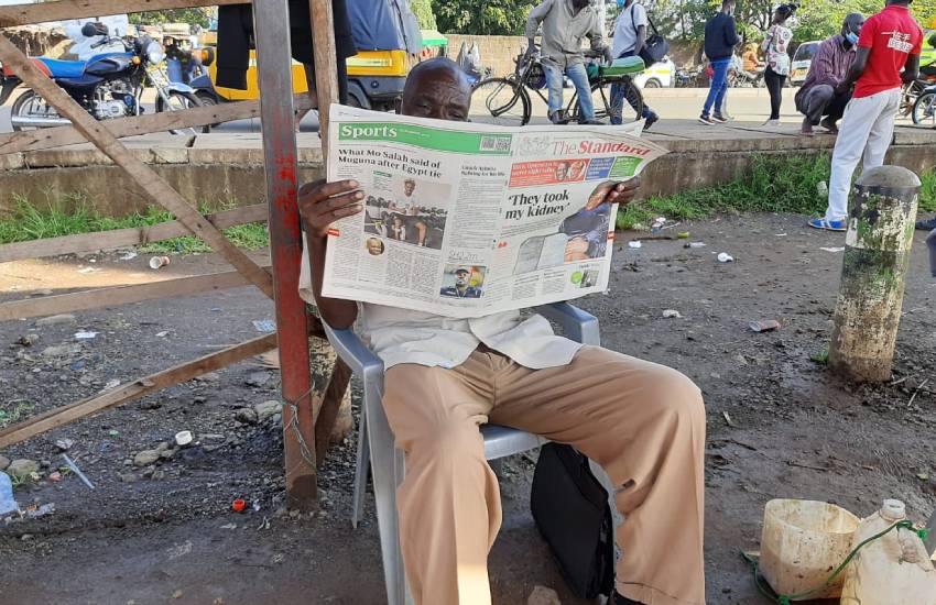 A customer reads a copy of The Standard at Kisumu 