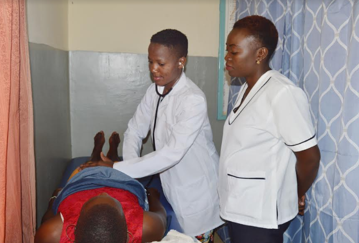 Mourine Andabwa, fourth Year student attends to patients at Mumias Hospital