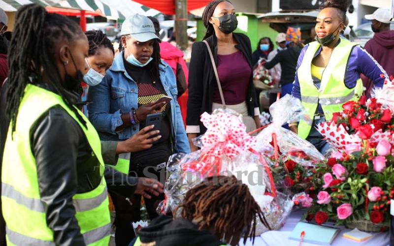 Clients at a flower stall outside City Market, Nbi