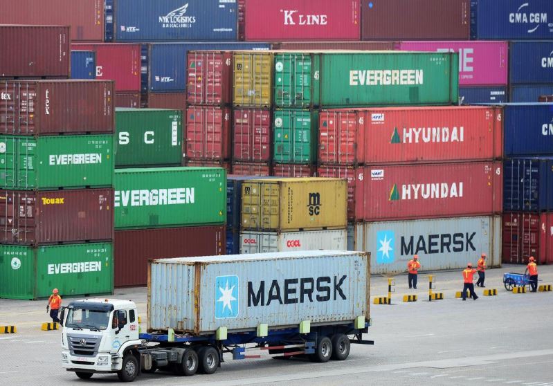 A truck transports a container at a port in Qingdao, Shandong province, China on July 11, 2019. [Reuters]
