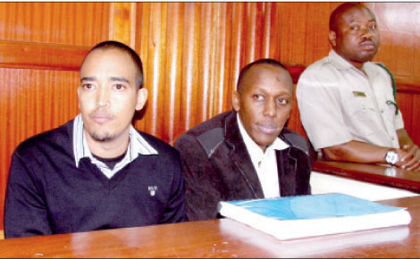 Alexander Chepkonga (left) with former police officer Dickson Munene in court during the hearing into the murder of James Nganga. [PHOTO: FILE/STANDARD]