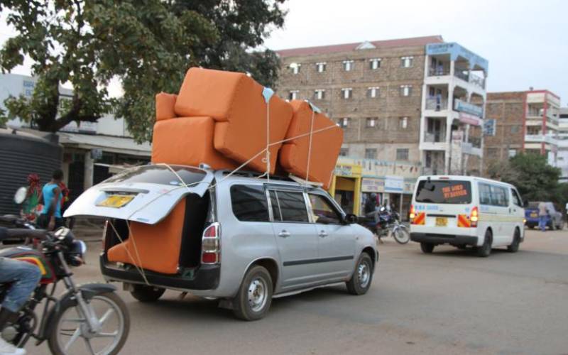 Probox transporting eight-sitter sofas, Migori.