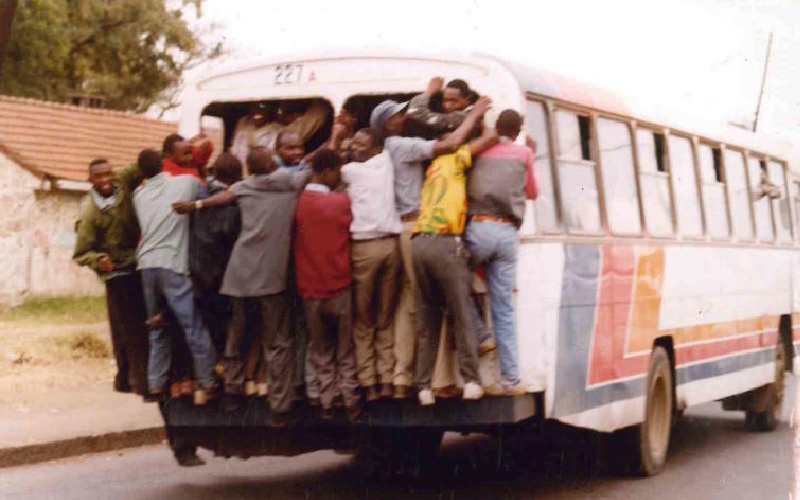 Men hanging on a bus along Jogoo Rd, 1999