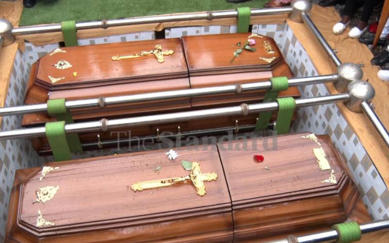 Brothers' coffins being lowered into grave