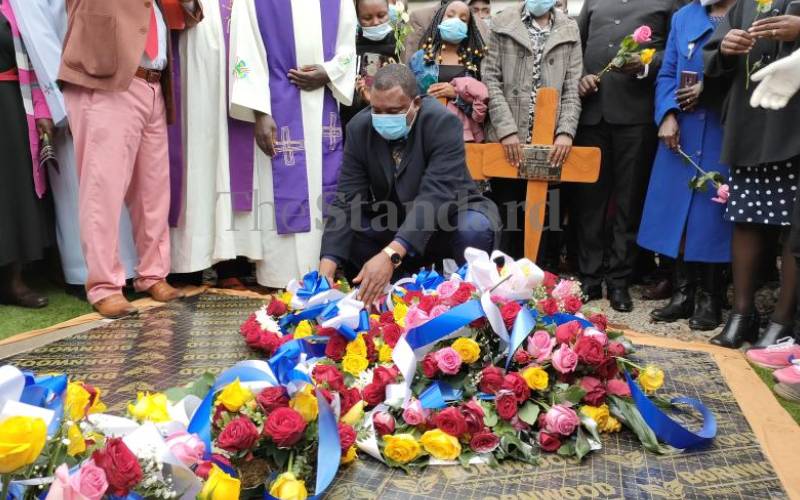 Speaker Justin Muturi laying a wreath on grave