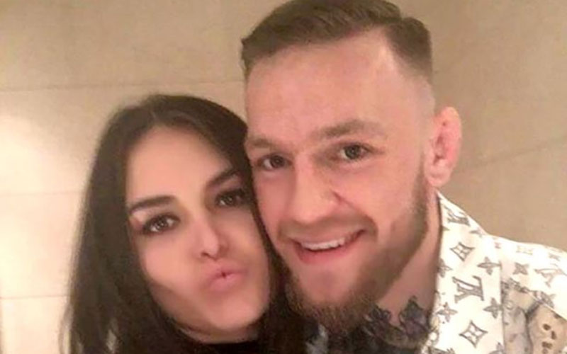 UFC champion Conor McGregor poses with long-term girlfriend Dee as he  returns home