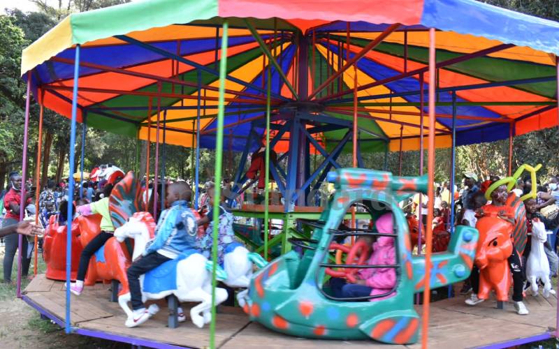 Children riding a merry-go-round. Fun!