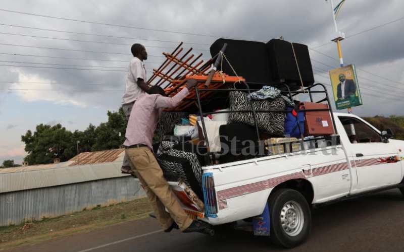 Men hanging on a pick-up in Homa Bay