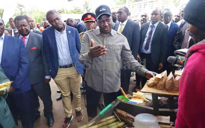 President Ruto consults a trader at Green Park.