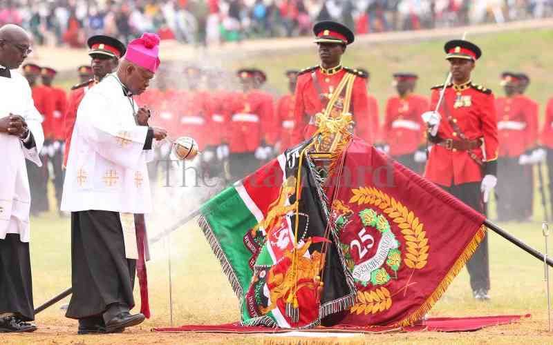 Clergy blesses flags during trooping of colours