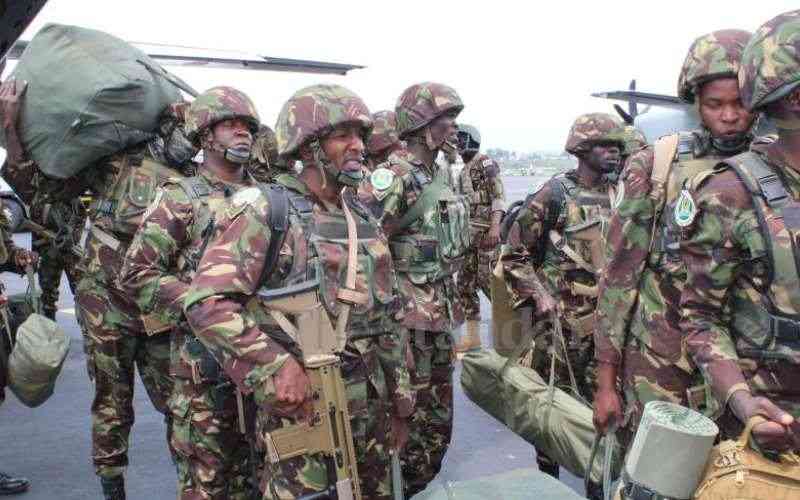 KDF troops offload luggage at Goma Airport.