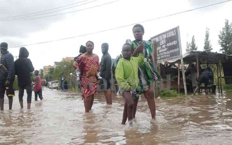 Residents, motorists navigate through flood waters