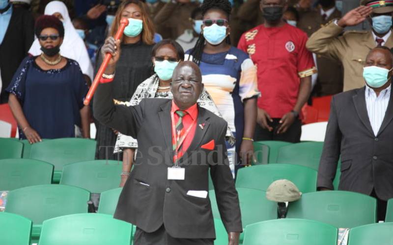 Guest waving a rungu at Uhuru Gardens.
