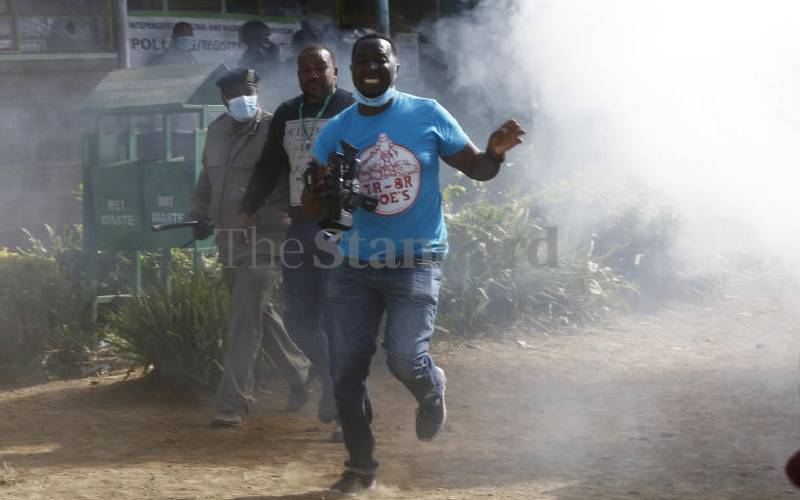 Journalist  fleeing from teargas at Milimani