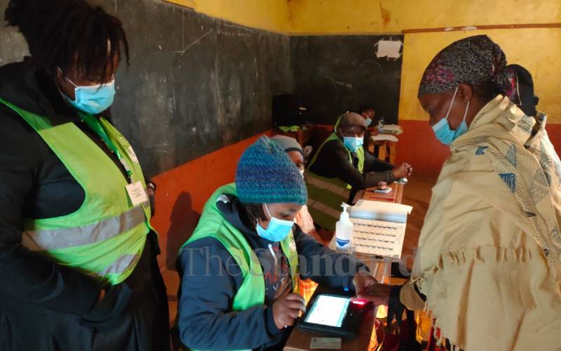 IEBC officials verifying voter details at Kiambaa