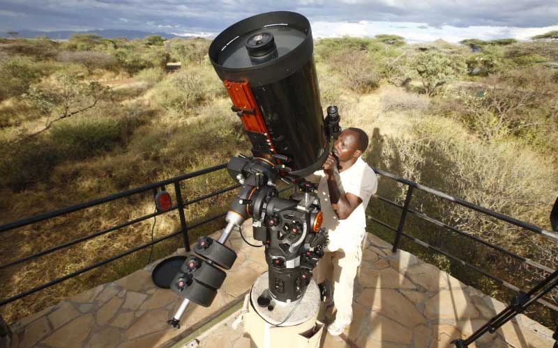 Tumbili Cliff Lodge manager operating the Celestron 14 that he uses to spy on the universe. [Kipsang Joseph]