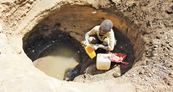 Lemeri Kobotek, 12, fetches water from a well in Nginyang, East Pokot. She walks more than 15km every day to the well. [PHOTO: BONIFACE THUKU/STANDARD]