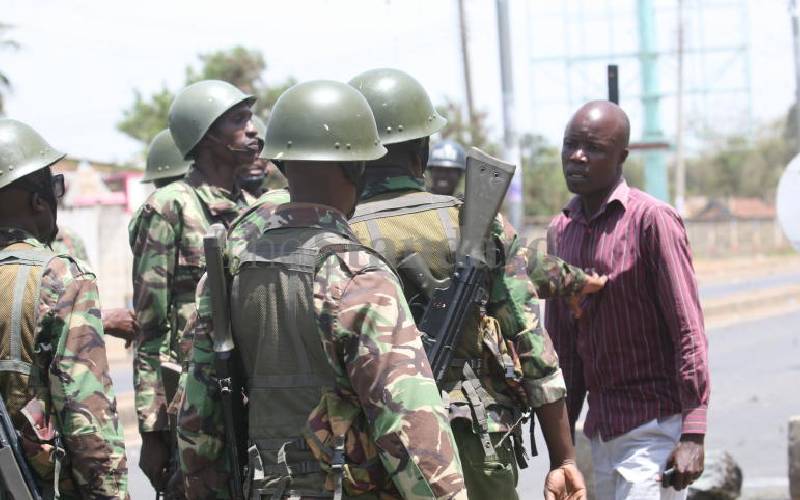Rashid Ronald restrained by police in Kisumu