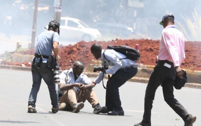 Journalists aiding injured rioter, Kisumu