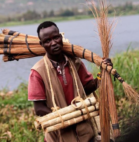 A hawker with his brooms that sells for Sh50 at Lwang’ni Beach in Kisumu. Many traders walk with their wares from door to door in order to reach the elusive market. 22-5-2019 [Phillip Orwa, Standard] 