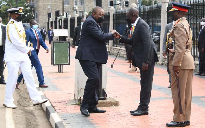 Pres. Kenyatta with Ruto outside Parliament. 