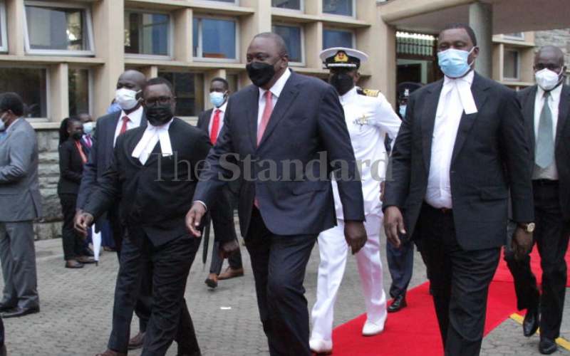 Kenyatta (C) being ushered into Parliament.