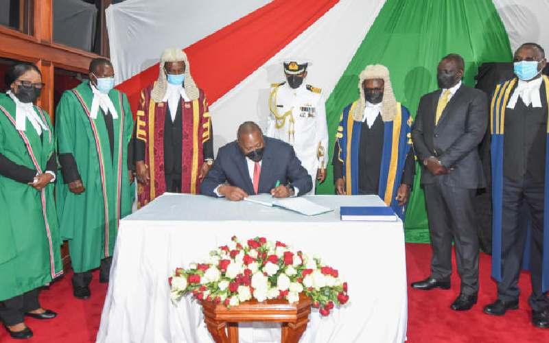 Pres. Kenyatta (seated) at Parliament Buildings.