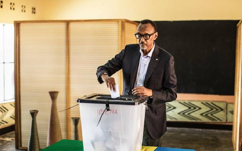 Rwandan President Paul Kagame proceeds to cast his vote in Kigali, on ...