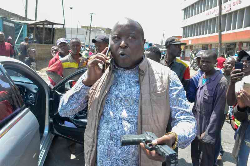 Nakuru Town West Mp Samuel Arama draws his gun after being confronted by demonstrators at Industrial Area in Nakuru City on July 19,2023 .Kipsang Joseph, Standard]