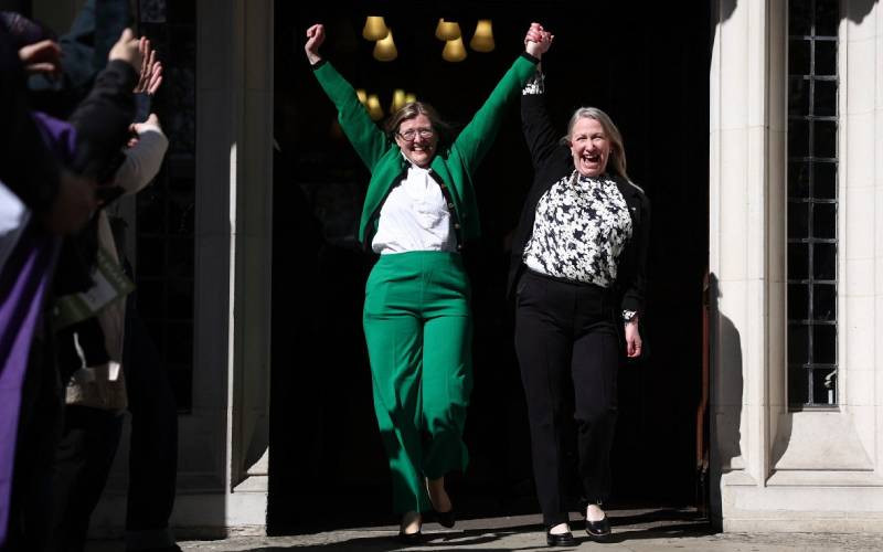 Susan Smith (L) and Marion Calder, Directors of For Women Scotland celebrate as they leave Britain's Supreme Court in London on April 16, 2025, following the court's ruling on how to define a 'woman'.