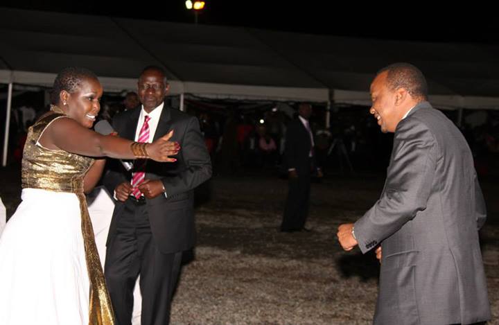 Emmy Kosgei dancing with Uhuru Kenyatta