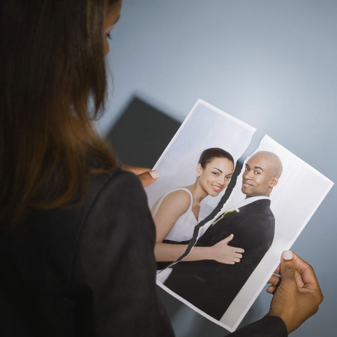 woman holding photo of husband