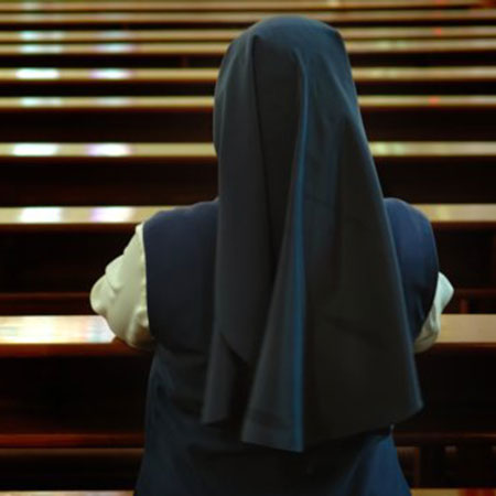 Nun praying in church