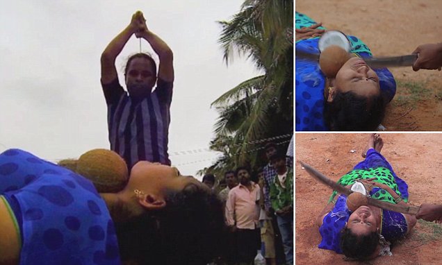 Man smashing coconut on woman's throat
