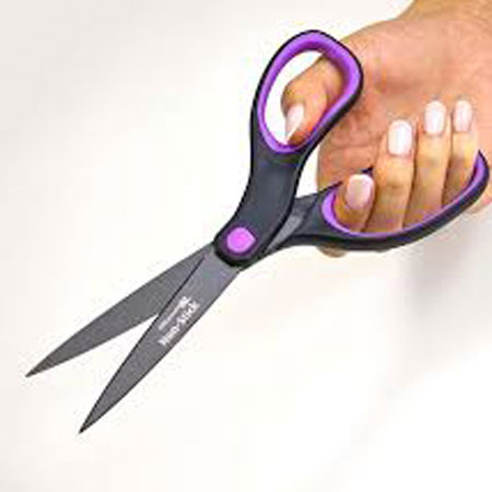 Woman's hand holding scissors